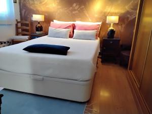 a large white bed in a room with two lamps at Manta Rota Beach, Bed & Breakfast in a villa,privat pool in Manta Rota +16 photos