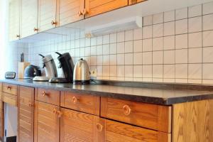 a kitchen with wooden cabinets and a counter top at Ferienhaus Winterberg in Winterberg