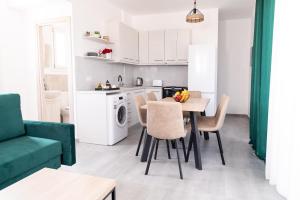 a kitchen and living room with a table and chairs at Saint Nicholas Houses in Kefalos