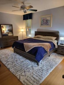 a bedroom with a large bed and a mirror at 5 Bedroom Bethel Maine home in Bethel