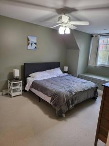 a bedroom with a bed and a ceiling fan at 5 Bedroom Bethel Maine home in Bethel