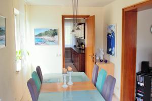 a dining room with a blue table and chairs at Ferienhaus Winterberg in Winterberg +13 photos