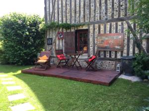 eine Terrasse mit Stühlen und einem Tisch im Hof in der Unterkunft Ancien Relais de Poste in Collandres-Quincarnon