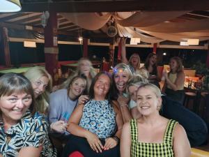 a group of women posing for a picture in a bar at DAMIA HOTEL Apts in Sidari