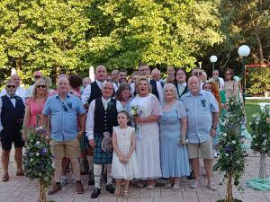 a group of people posing for a picture at a wedding at DAMIA HOTEL Apts in Sidari