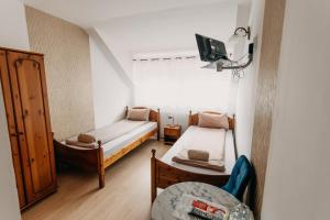 A bed or beds in a room at Palma Vendégház