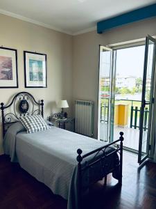 a bedroom with a large bed and a balcony at Luena Home Luxury Apartment in Brusciano +22 photos
