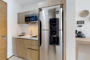 a large stainless steel refrigerator in a kitchen at Perfect Place 311 in Playa del Carmen