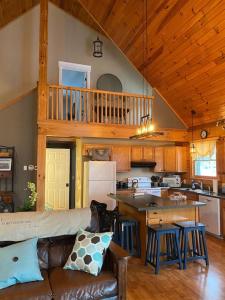 a living room with a couch and a kitchen at Beautiful Log Home, Lake side. in New Hope