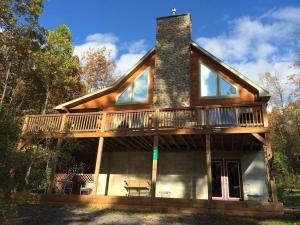 a house with a wrap around porch with a deck at Beautiful Log Home, Lake side. in New Hope