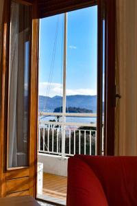 a room with a door open to a balcony with a view at Ciceri Properties Montebello in Verbania