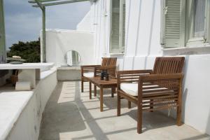 two chairs and a table on a balcony at Traditional Village House in Istérnia