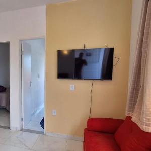a living room with a flat screen tv on the wall at Apartamento Novo em Piranhas in Piranhas