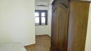 a hallway with a wooden door and a window at Mandorlo 2 in Santa Maria Navarrese