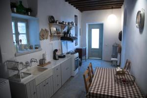 a kitchen with a table and a dining room at Traditional Village House in Istérnia