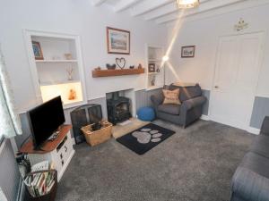 a living room with a couch and a television at 31 Outgang Road in Pickering