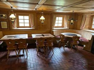 a dining room with a table and chairs at Hotel Tschuggen Davos in Davos