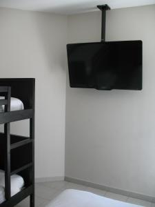 a flat screen tv hanging on a white wall at Fasthotel Montpellier Baillargues in Baillargues