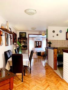 a kitchen and living room with a table and chairs at Villa Urbana, Old Town Budva in Budva