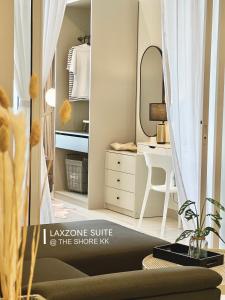 a dressing room with a mirror and a dressing table at The Shore CBD Kota Kinabalu By LAXZONE SUITE in Kota Kinabalu