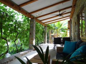 an outdoor living room with a wooden pergola at Istrian Stone House with a big garden in Marezige