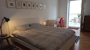a bedroom with a bed and a table and a patio at Apartment LAUREL Center Opatija in Opatija