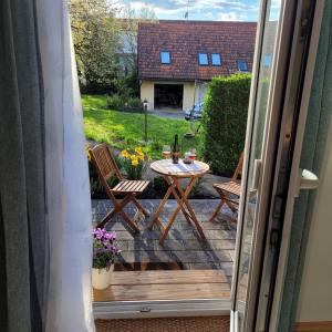 an open door to a patio with a table and chairs at Kuschelige Maisonette in Lannach