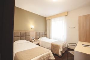 Postel nebo postele na pokoji v ubytování Curitiba Palace Hotel