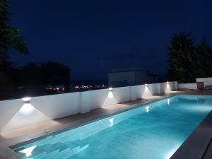 a swimming pool at night with lights around it at Casa A.Mar in Las Negras