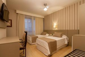 Postel nebo postele na pokoji v ubytování Curitiba Palace Hotel