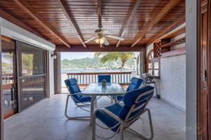 a dining room with a table and chairs on a porch at CasaPisani Tranquil 2Bed condo SimpsonBayYachtClub in Simpson Bay
