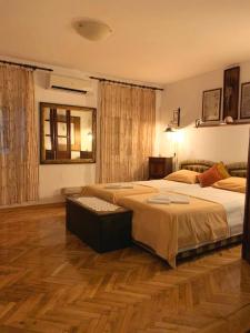 a bedroom with two beds and a wooden floor at Villa Urbana, Old Town Budva in Budva