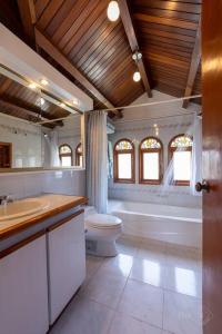 a bathroom with a toilet and a sink and a tub at CasaPisani Tranquil 2Bed condo SimpsonBayYachtClub in Simpson Bay