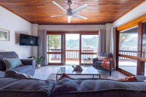 a living room with a couch and a ceiling fan at CasaPisani Tranquil 2Bed condo SimpsonBayYachtClub in Simpson Bay