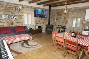 a living room with a bed and a table and a couch at Apartment Rural Podastrana in Sinj