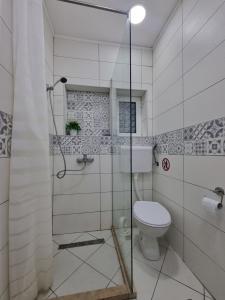a bathroom with a toilet and a glass shower at R&S Apartments in Herceg-Novi +20 photos