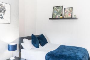 een slaapkamer met een bed met een blauwe deken bij WhereToStay Entire 2bed House in Barrow in Furness