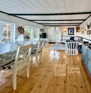 a large living room with a table and chairs at Southern cottage with terrace and magnificent view in Lillesand