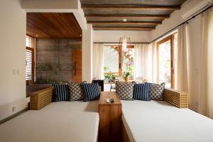 a living room with a couch and a table at Santa Aldeia Hotel in Arraial d'Ajuda