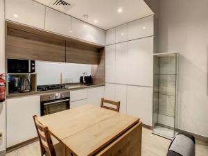 a kitchen with a wooden table in a kitchen at Key View - Studio One in Dubai