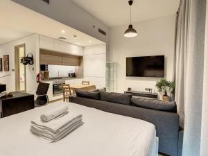 a living room with a bed and a couch at Key View - Studio One in Dubai