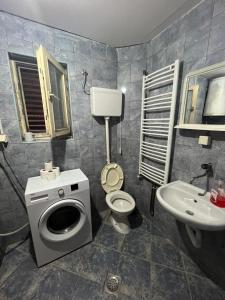 a bathroom with a toilet and a sink at Villa Natalija in Podgorica