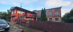 a house with a fence in front of it at Guest House LIBU Zugdidi in Zugdidi