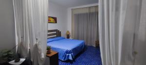 a bedroom with a bed with a blue floor at Casa OASI in Formia