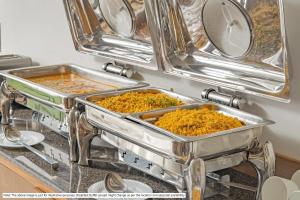 two trays of food sitting on top of a counter at Treebo Trend Akshaya Mayflower Vijaya Bank Layout in Bangalore