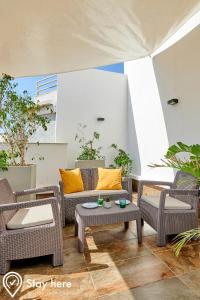 a patio with chairs and a couch and a table at Stayhere Rabat - Agdal 3 - Prestige Residence in Rabat