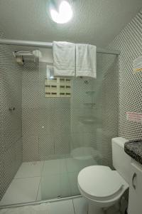 a bathroom with a glass shower with a toilet at Pousada Brisa do Atlântico - Praia de Iracema - Próximo a feira da Catedral da sé in Fortaleza