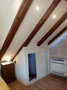 a attic room with a large screen tv and wooden beams at Apartments & Rooms Trogir Stars FREE PARKING in Trogir