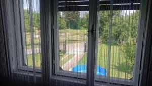 a window with a view of a yard at Apartman Brzak in Zagreb