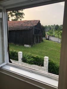 a window view of a yard with a building at Kuca za odmor Lucija in Zagreb